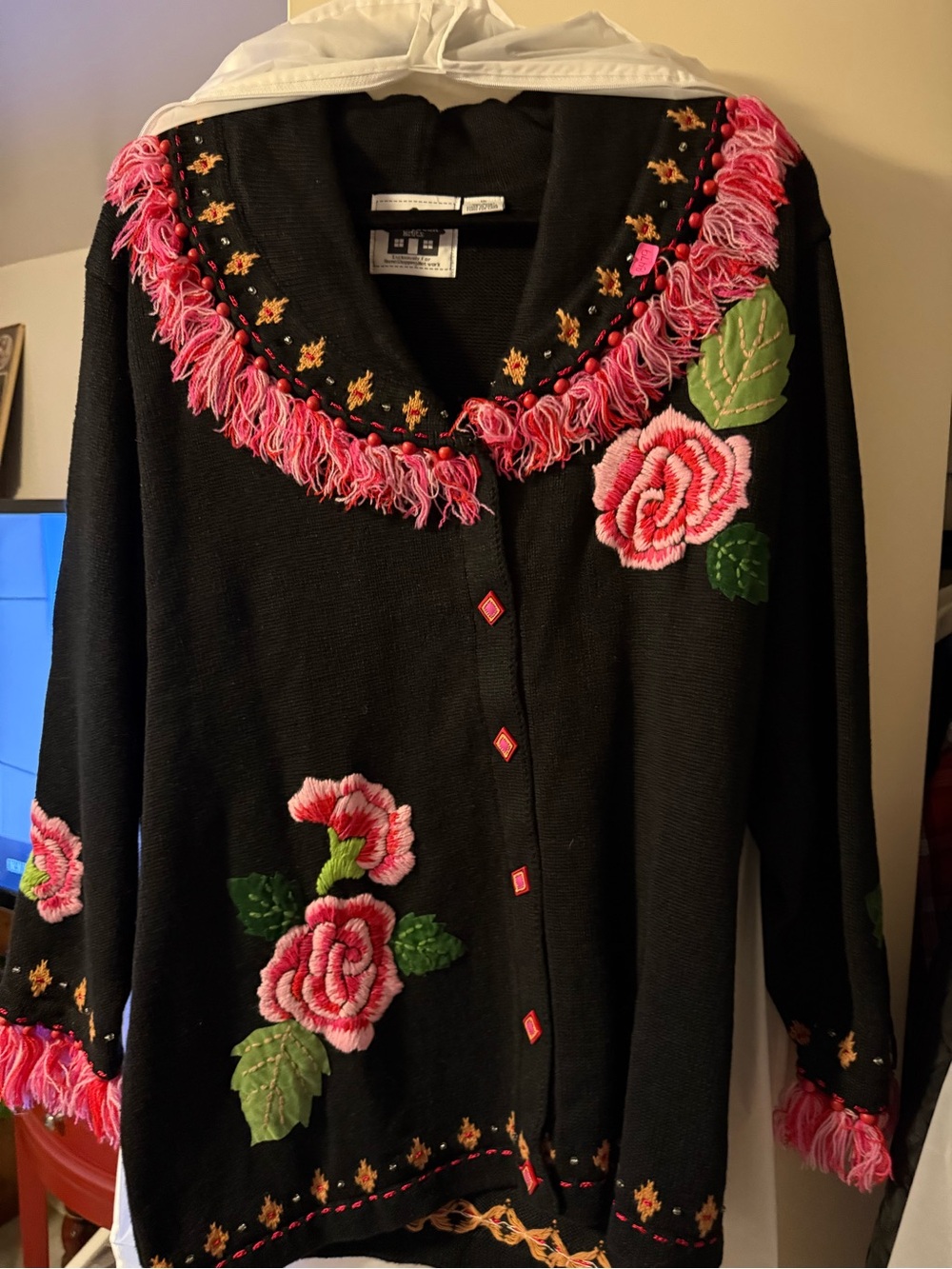 Storybook Knits Black Cardigan with Pink Floral Embroidery and Fringe Trim